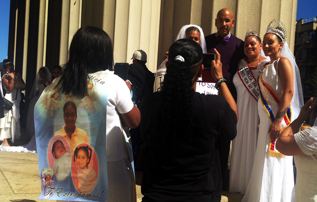 One mother of domestic violence victims wears a banner of her daughter and her granddaughters in honor of their memory.