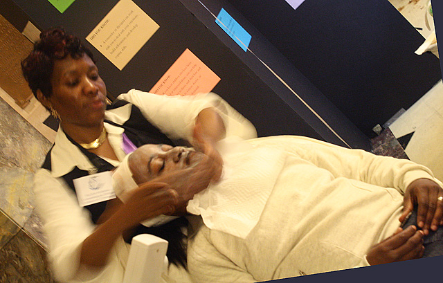 Bronx-esthetician-prepares-to-place-two-slices-of-cucumbers-on-her-customer.